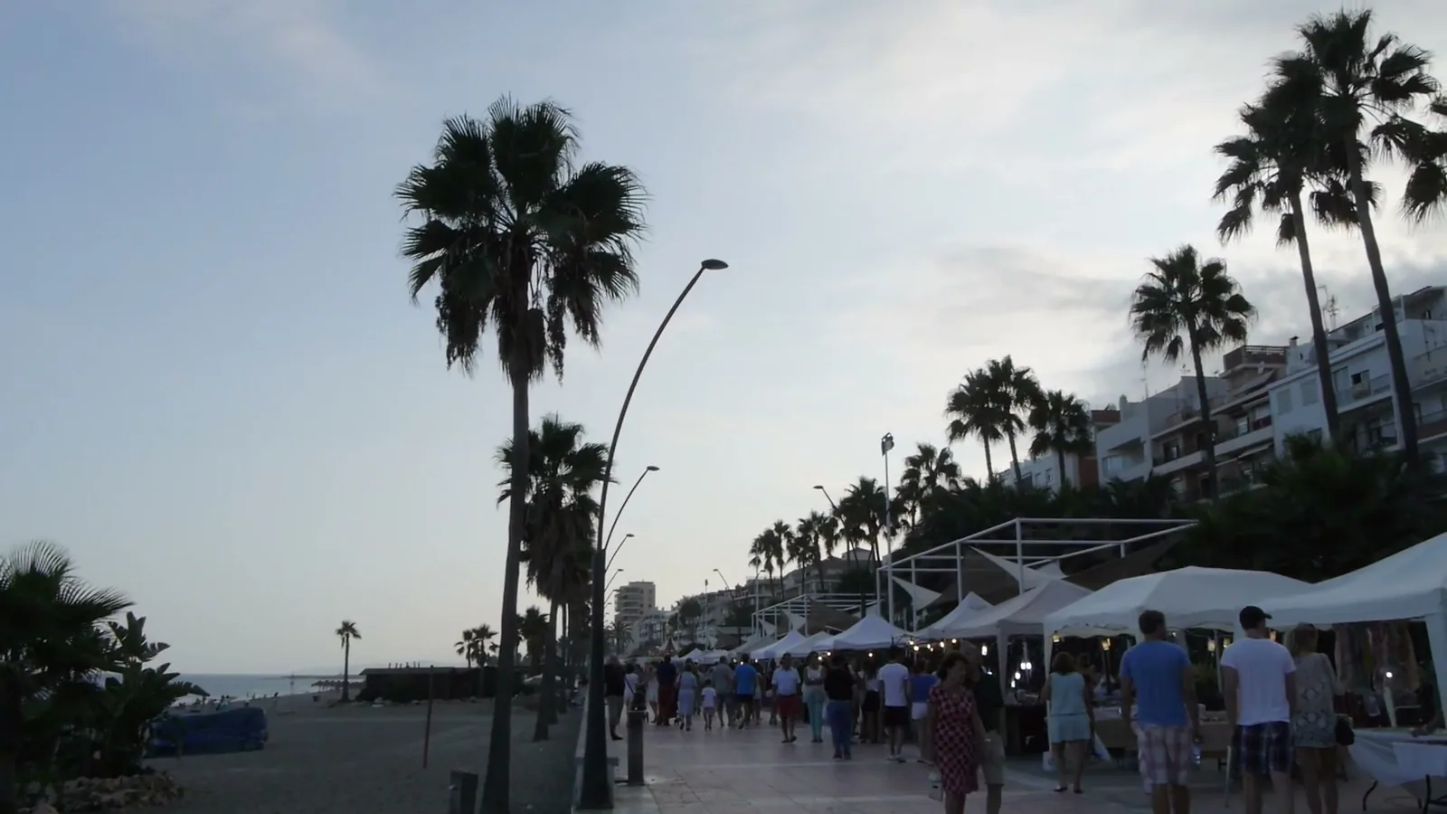 The Paseo Marítimo of Estepona at dusk, with palm trees and the marquees of the first edition, 2014