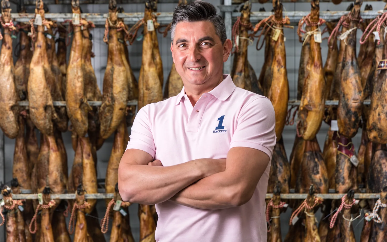 Portrait of José María Téllez “Popi” beside his hams, 2018