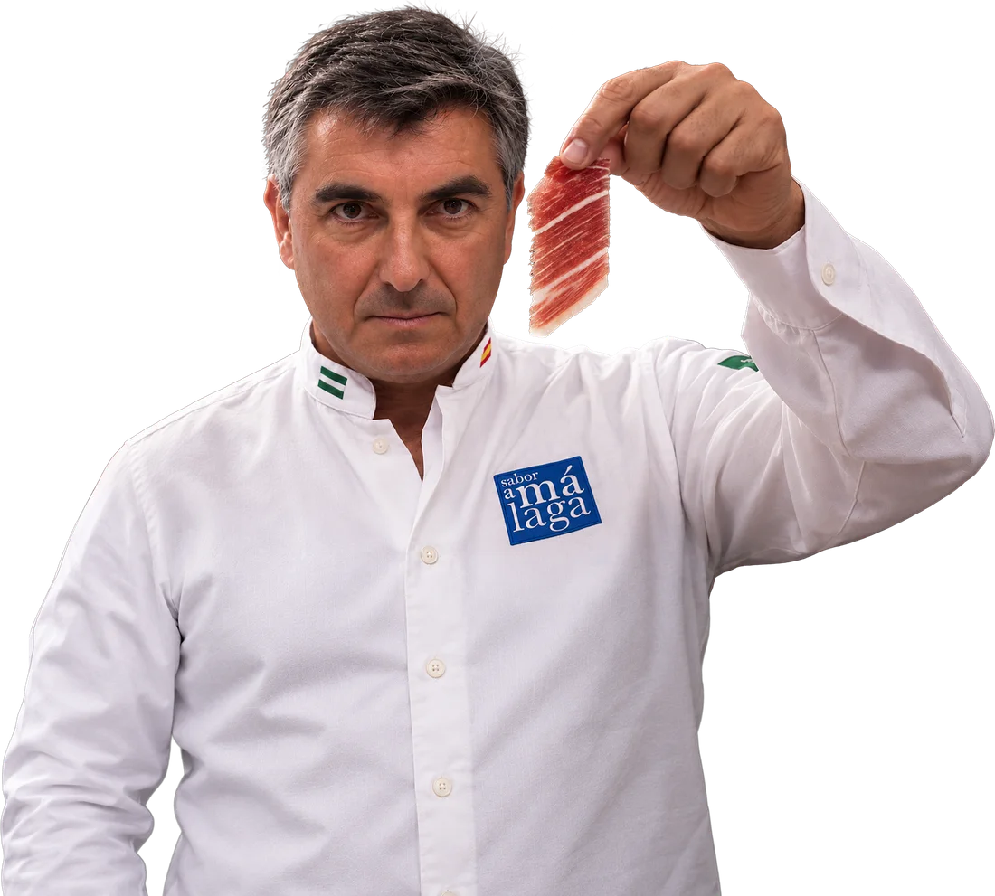 José María Téllez, «Popi», holding a slice of Iberian ham